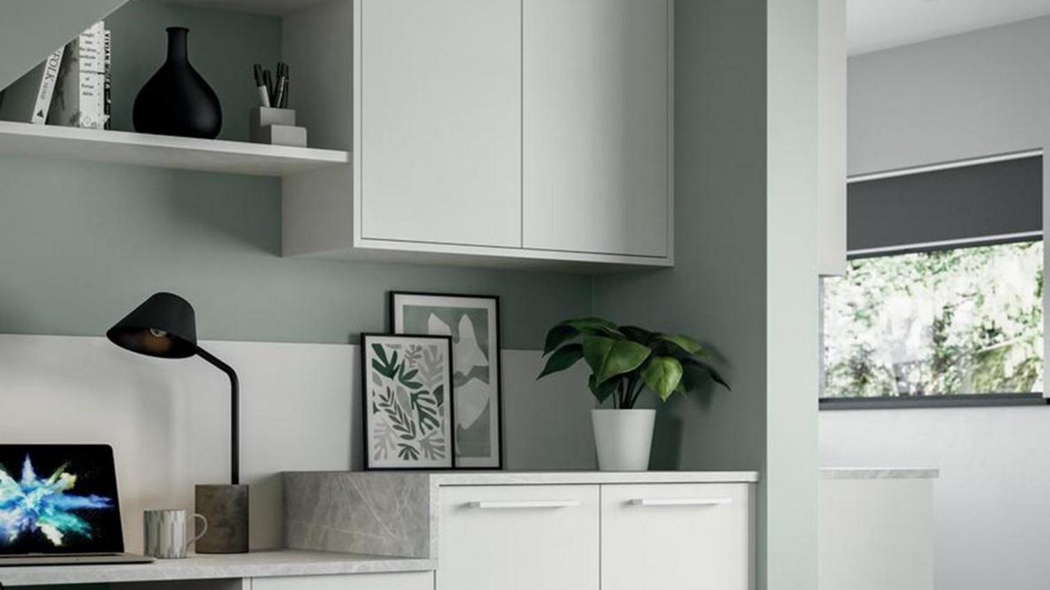 Home office storage idea in a Greenwich Gloss White kitchen, using wall, base, and drawer cabinetry for storage.