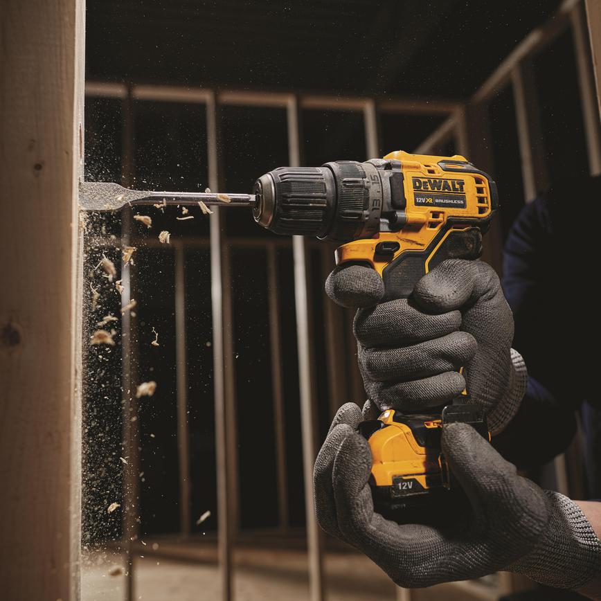DeWalt DCD701D2 brushless driver being used by a trade professional into timber material.
