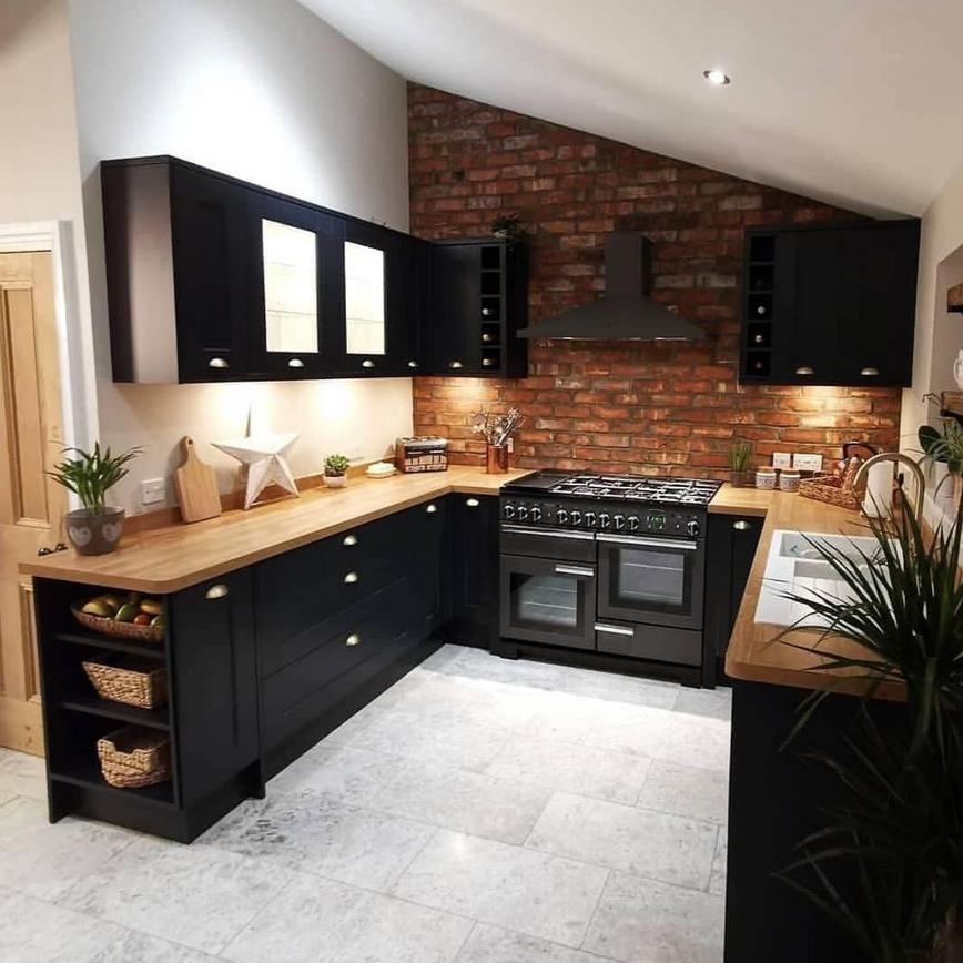U-shaped kitchen with navy kitchen doors, wooden worktops and glazed wall units