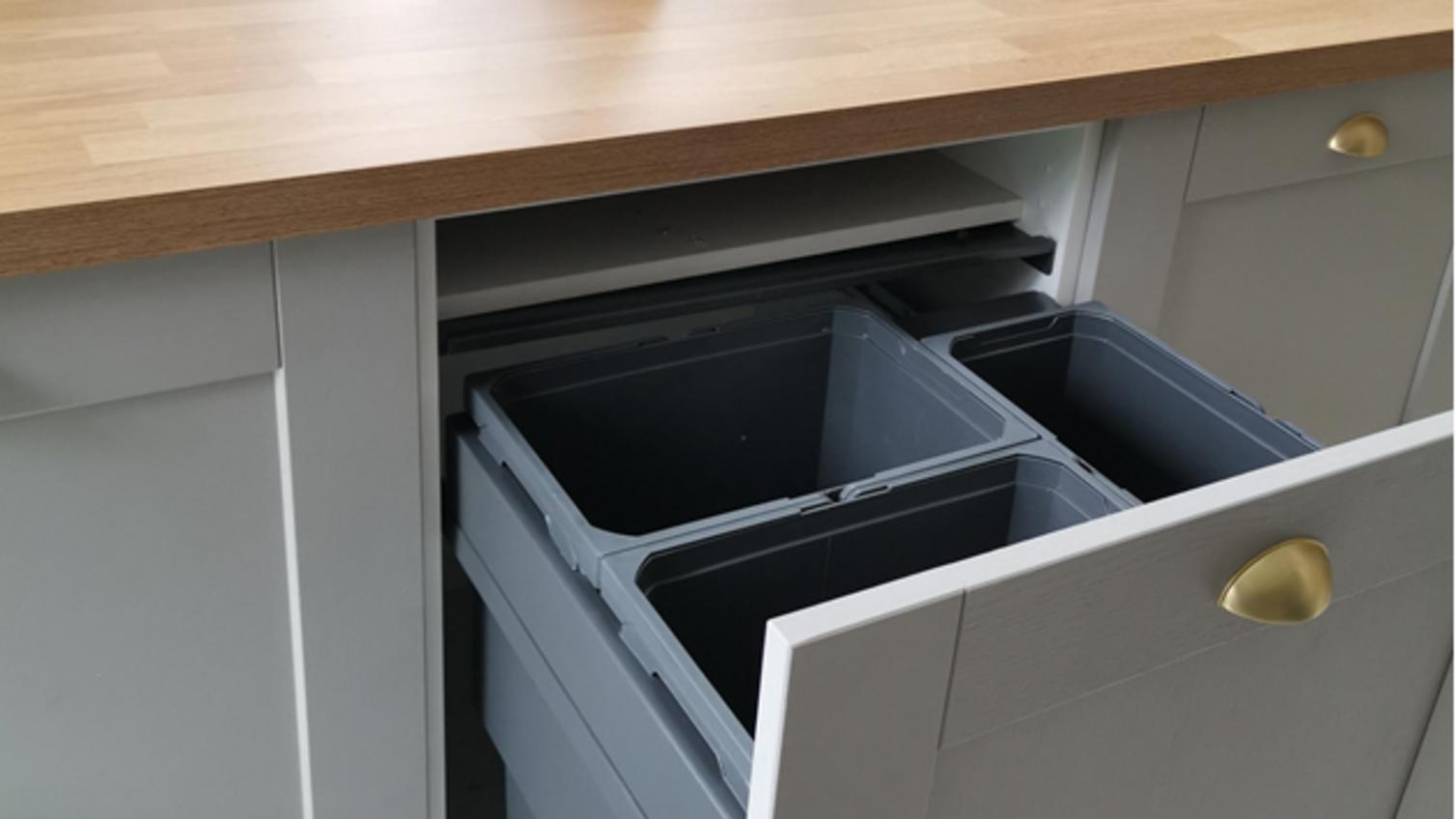 Kitchen bins integrated within a grey shaker kitchen island design