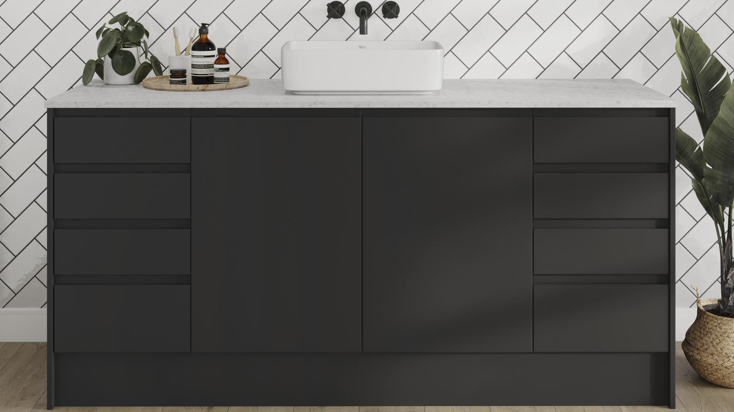 A modern bathroom idea featuring black, integrated handle cupboards. It includes white worktops, tiles, and timber floors.