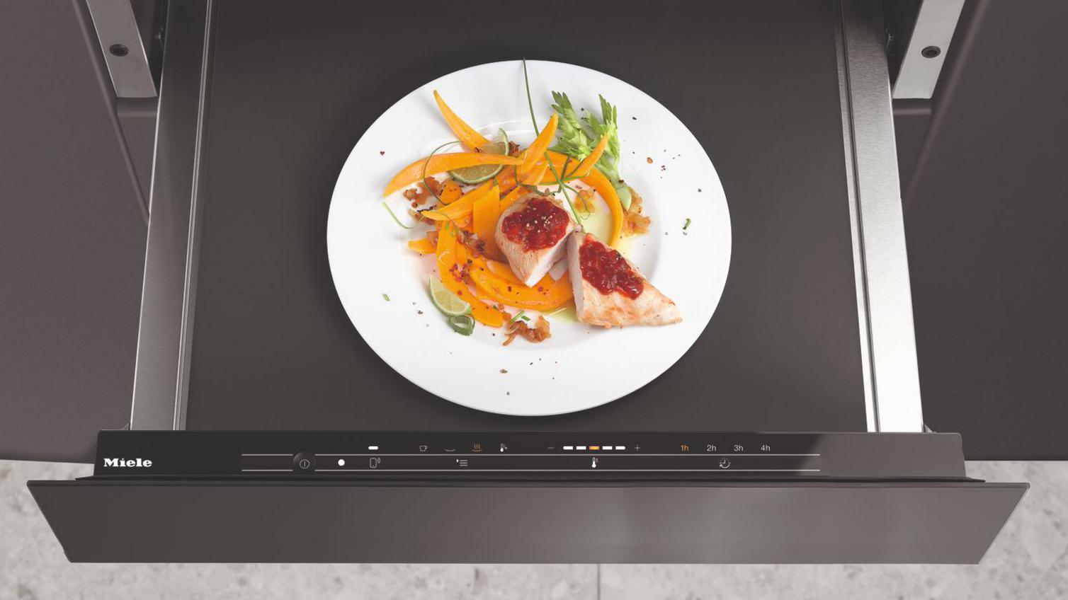 Miele ESW7010 warming drawer with a plate of cooked food