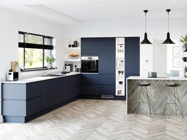 Navy blue handleless super matt kitchen in l shape layout with marble worktop and full height built in open shelving.