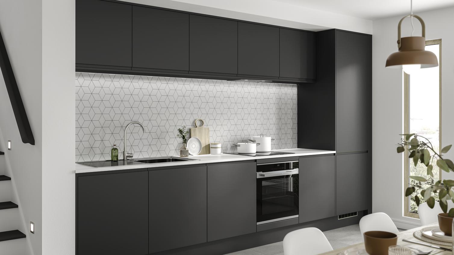 Ultra-modern black kitchen idea in a single wall layout. Has matt charcoal integrated handle units and a geometric backboard.