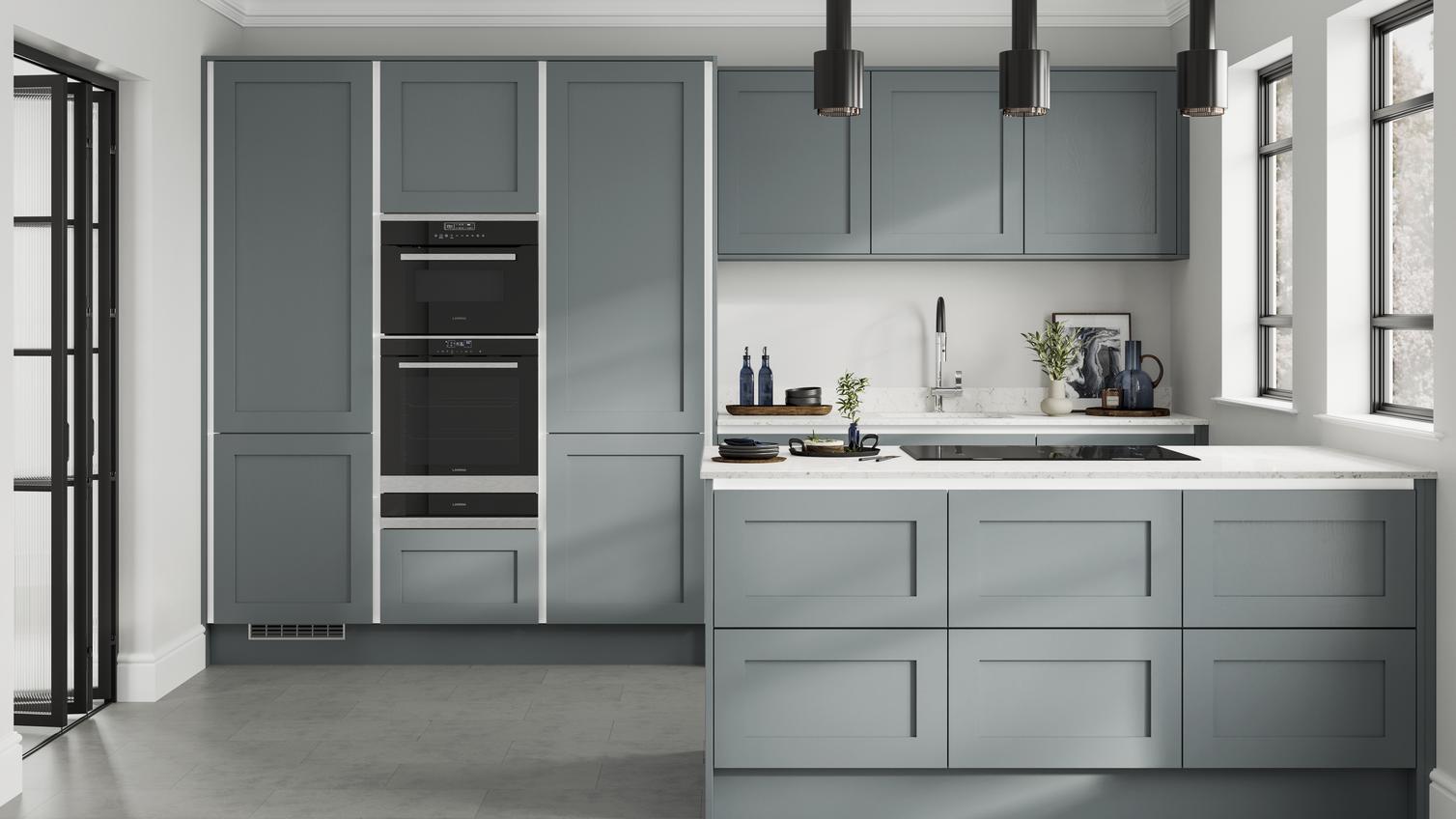 Handleless dusk-blue shaker kitchen with white trims in a peninsula layout. Contains double drawer units and grey floors.