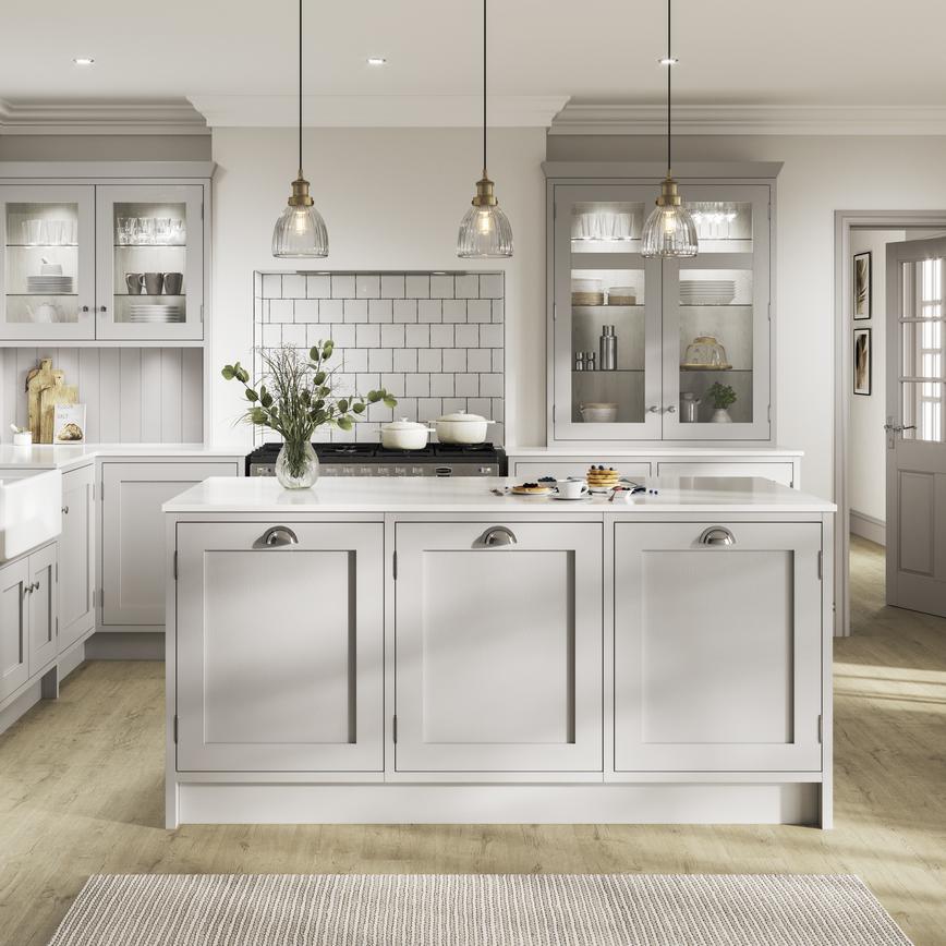 Grey shaker kitchen with an in-frame design in an island layout. Contains exposed hinges, chrome handles, and white worktops.