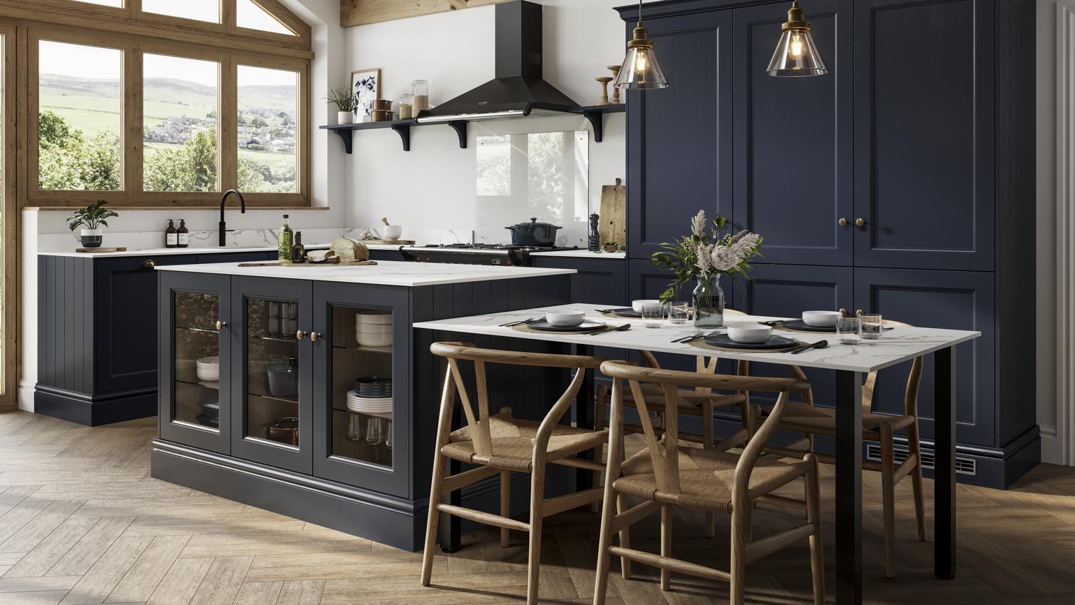 Navy shaker doors with a beaded detail in an island layout. Includes a black extractor, white worktops, and tower units.