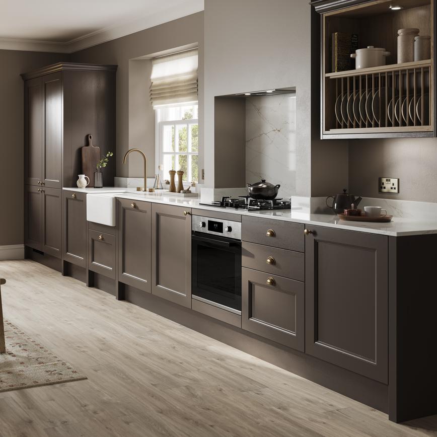 A truffle-brown shaker kitchen in a single wall layout. It has a glass dresser cabinet, white worktops, and wood flooring.