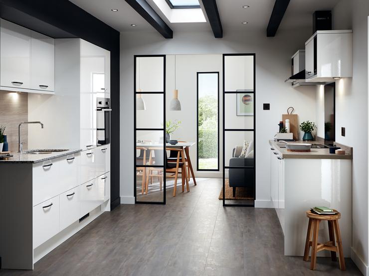 A slab kitchen design within a kitchen extension that uses a broken-plan style for kitchen and dining