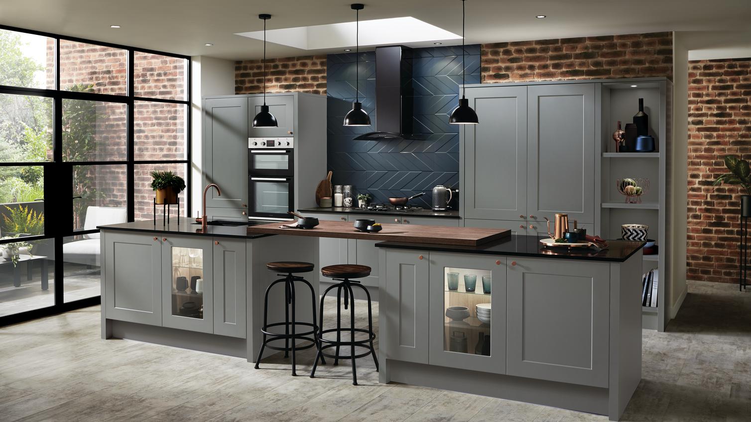 Sophisticated slate grey kitchen with a double island layout. Featuring exposed brick, dark wood tones and black accessories.