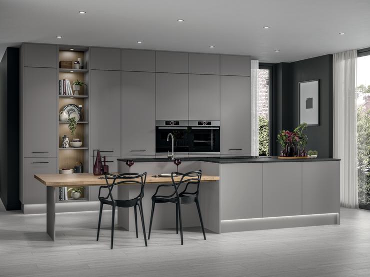 Slate grey super matt kitchen with contrasting black handles, black kitchen worktop with two single built in electric ovens.