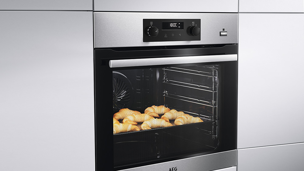 A silver built in AEG oven.