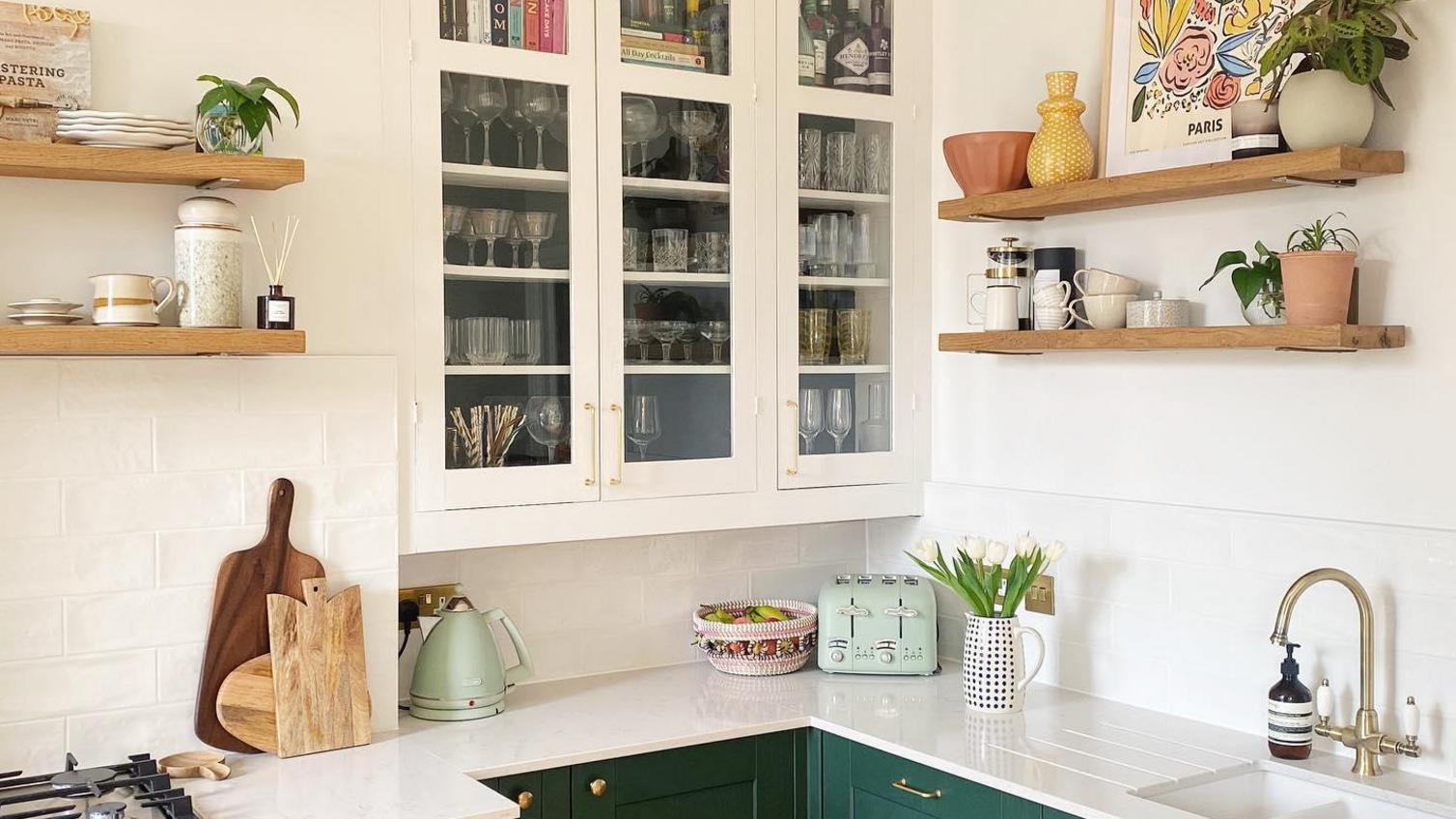 Kitchen storage idea using shelves and glass doors for wall-mounted storage for cups and books.