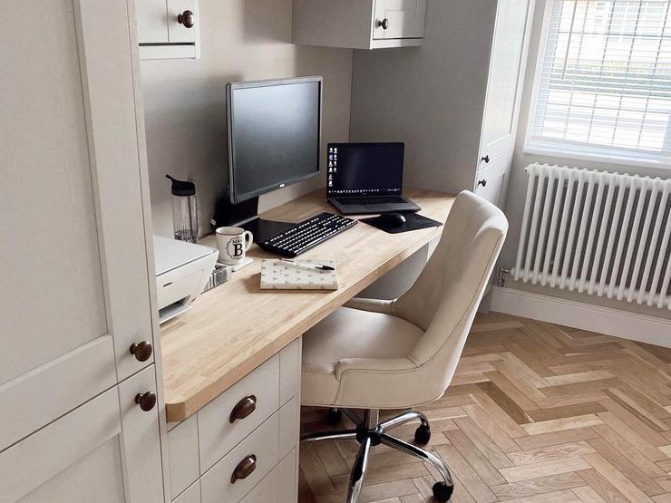Grey home office makeover with shaker doors, light wood chevron flooring, light oak worktop, and knob handles.