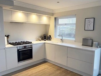white integrated handle kitchen and warm white ceiling lights