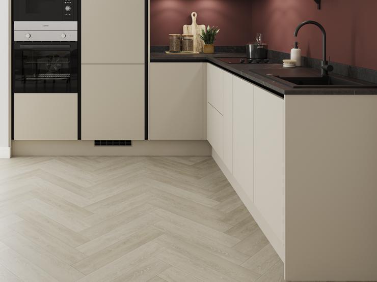Greenwich Sandstone handleless kitchen with an oak luxury vinyl flooring in a herringbone pattern