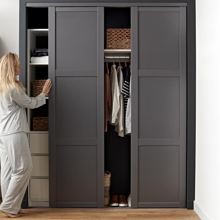 Built in wardrobe with sliding wardrobe doors in a framed, grey design.