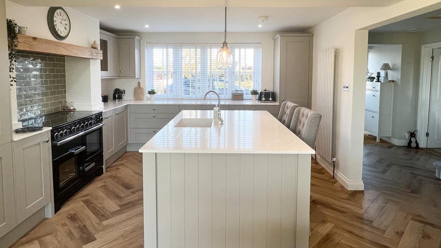 Fairford pebble open plan kitchen, with herringbone luxury vinyl flooring between kitchen and living room areas.