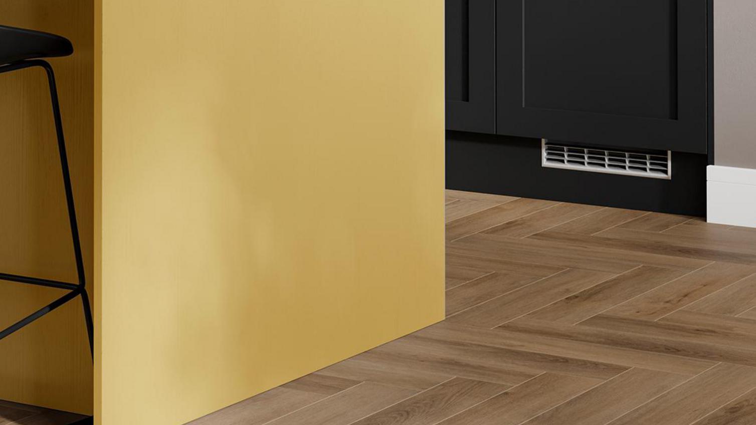 A paintable Chilcomb kitchen in black and yellow, with oak-effect chevron flooring.