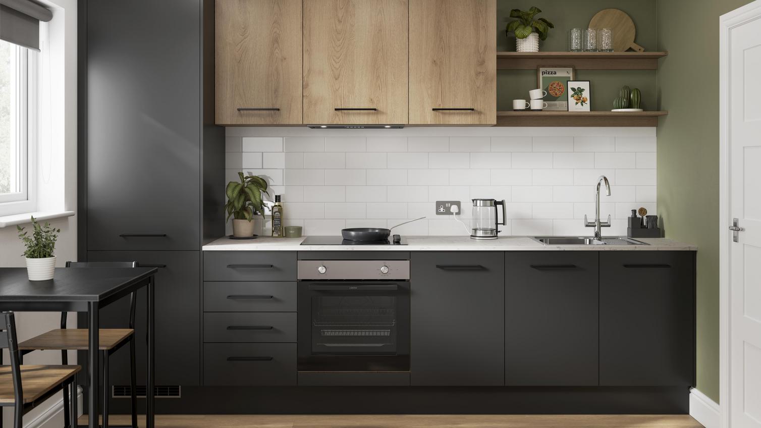 A two-tone, one wall kitchen, with dark, charcoal-coloured cabinetry and some oak cabinets that match the floor