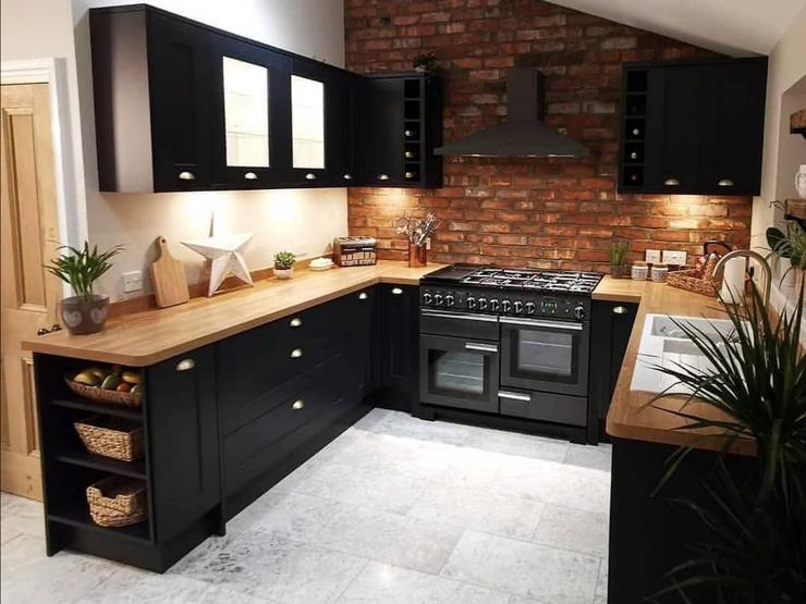 U-shaped kitchen with navy kitchen doors, wooden worktops and glazed wall units