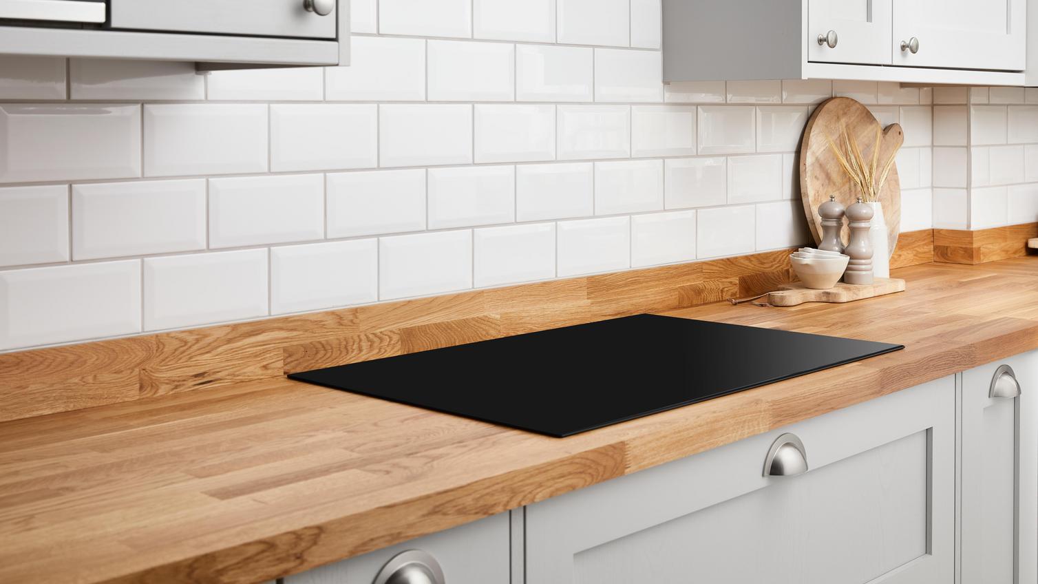 An induction hob set into a Howdens timber worktop