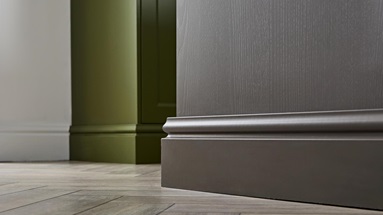 Decorative plinths fitted to two sets of shaker cabinetry. The plinths match the green and brown colours of the units.