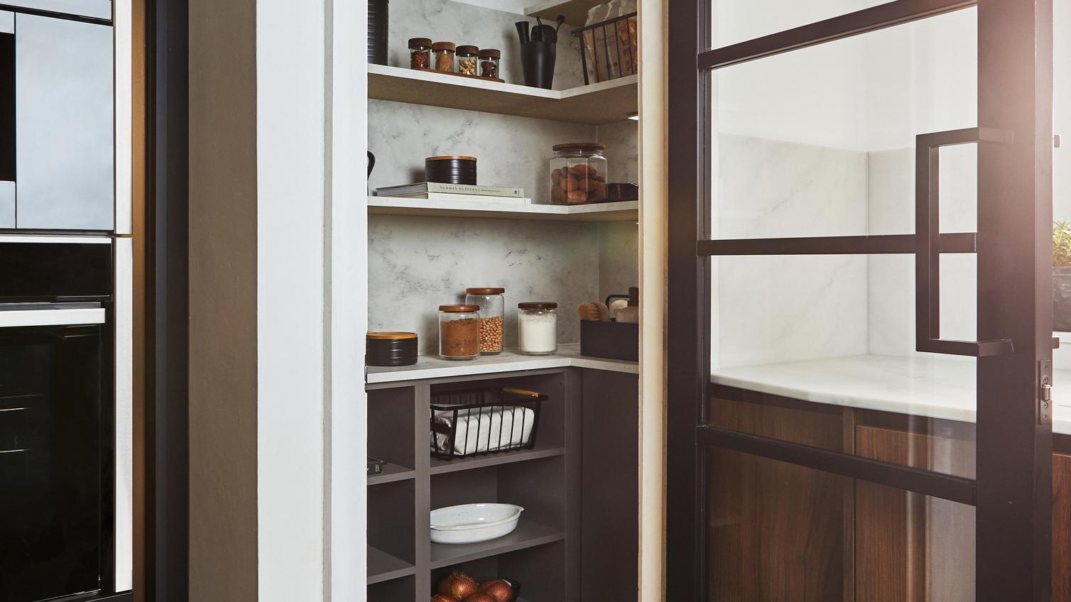 A compact pantry featuring built-in and open shelving shelving. Includes a glazed door with a black frame for a modern look.