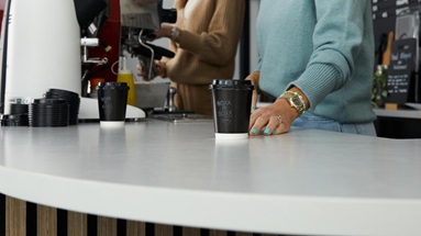 Jill and Shelly at the counter, serving a takeaway coffee