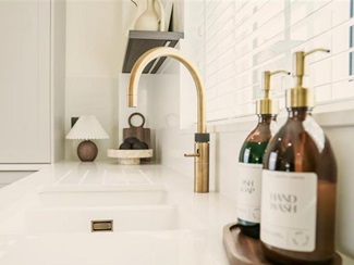 A swan neck tap in a brass finish