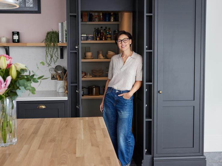 Emma posing in front of her secret pantry space