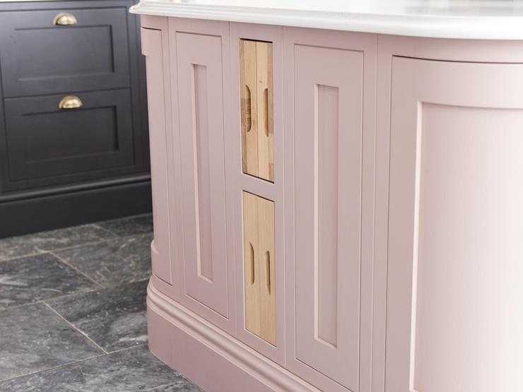 Timber accessories inside a pink, in-frame kitchen
