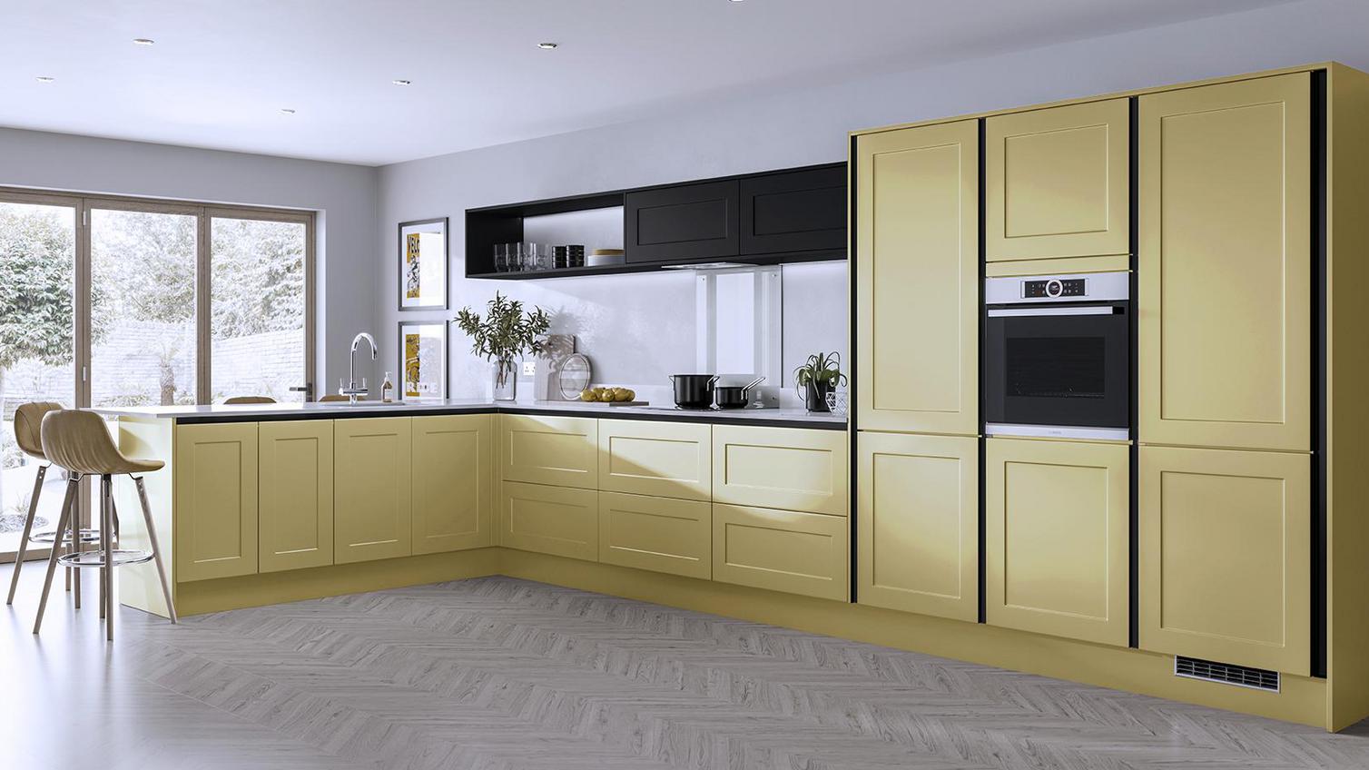 Yellow fitted kitchen using our Chelford paintable handleless collection, with black profiles and white worktops.