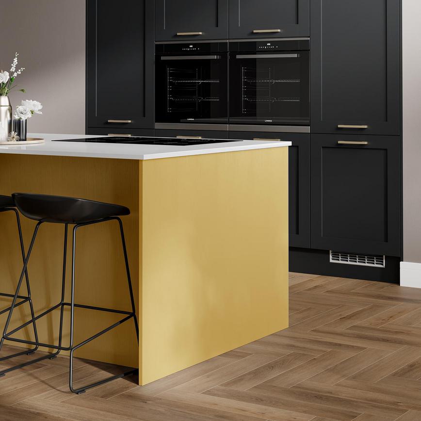 Yellow paintable kitchen idea with an island layout, oak herringbone flooring, black wall cupboards and integrated devices.