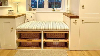 white boot room idea using shaker kitchen doors, wooden worktops and wicker baskets.