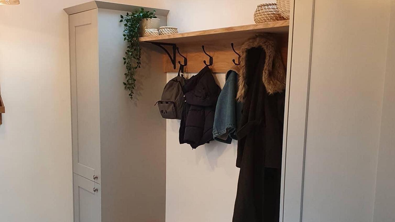 Grey boot room idea using shaker kitchen doors and tower units. Includes coat rack and bench.