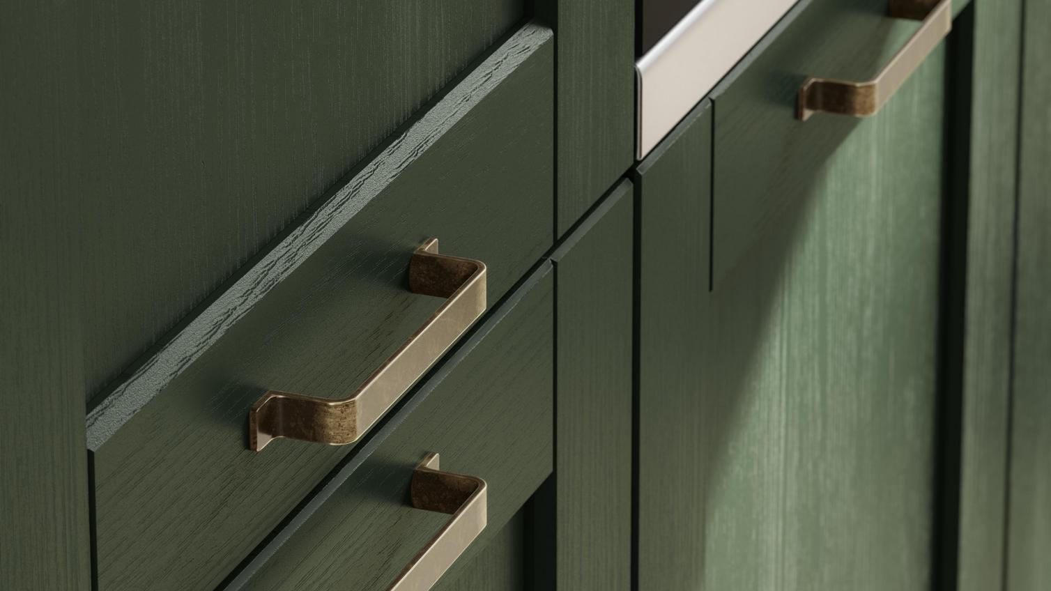 Metallic cabinet handles used with a textured green cupboard door