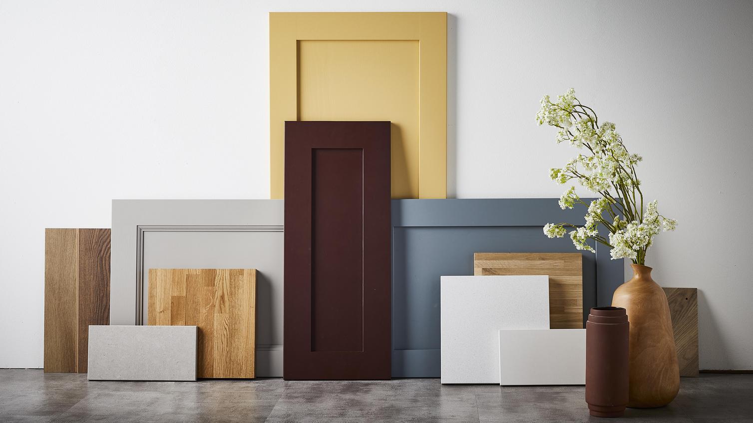 Crafted flat lay with shaker doors in different sizes and colours including, maroon, blue, light grey, and yellow.