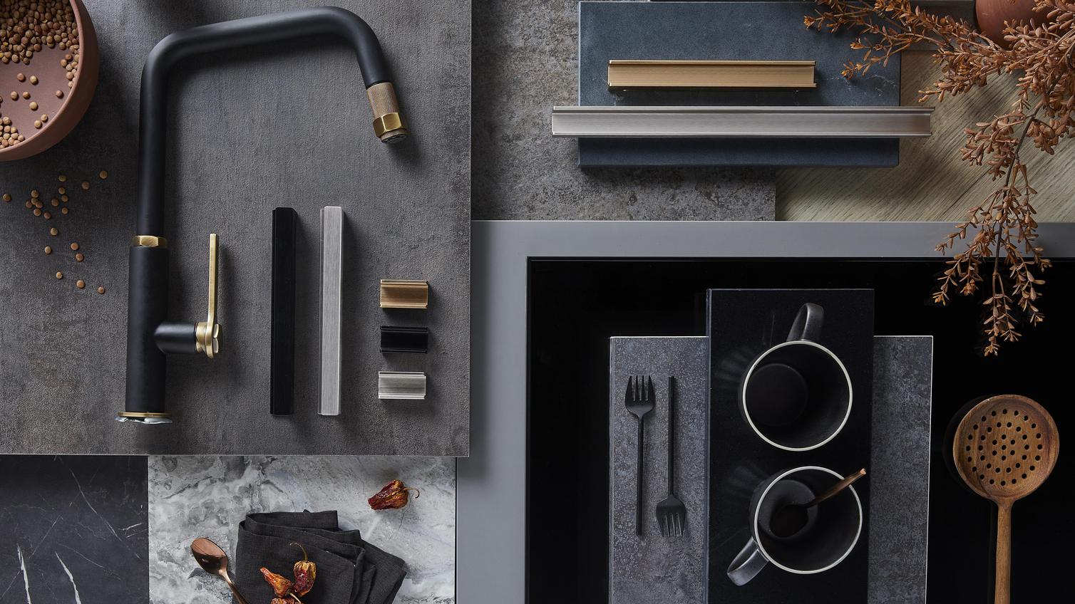 Sensory delight flat lay showing charcoal and navy shaker doors, textured stone, black handles and brushed chrome fixtures.