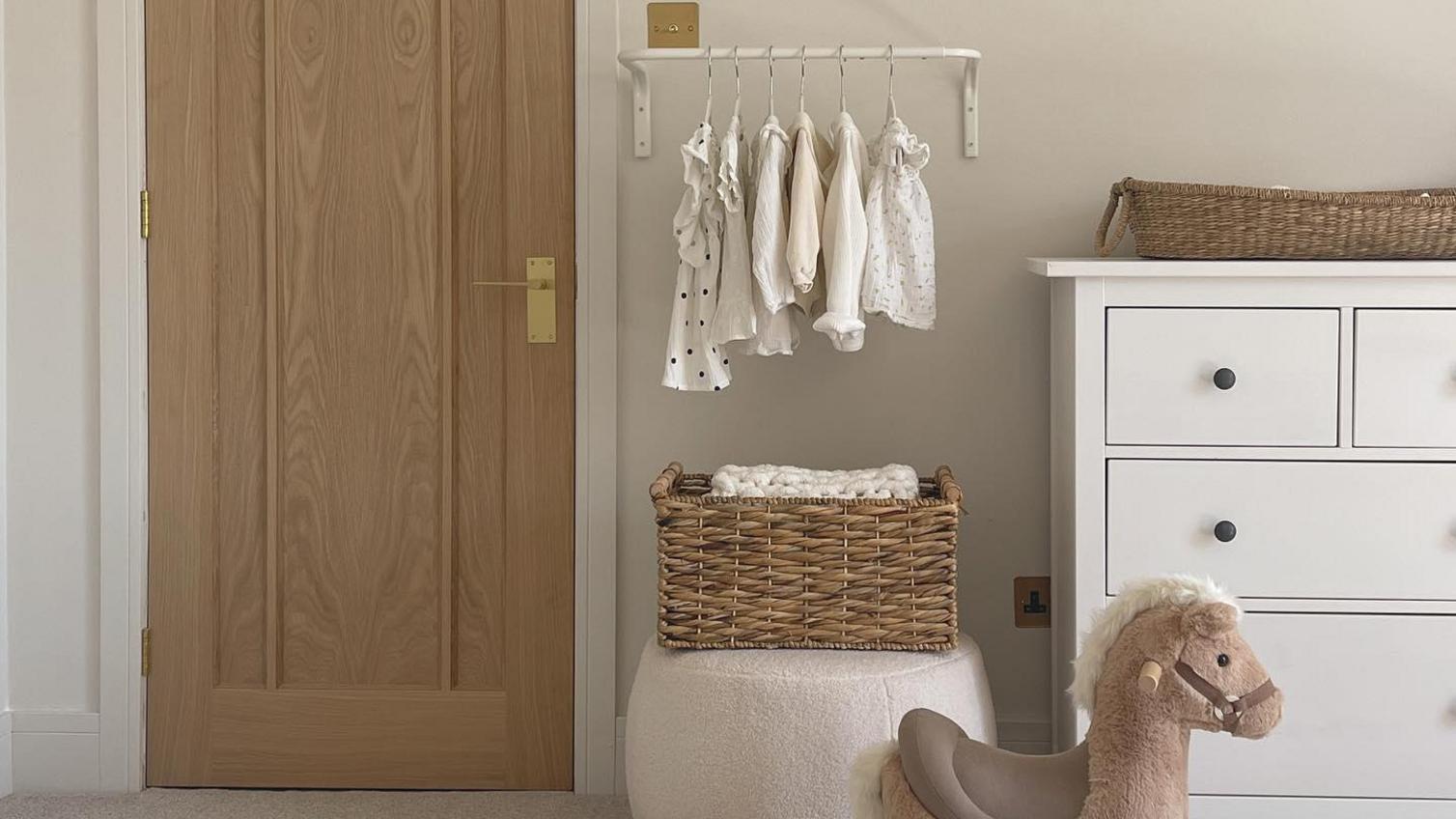 An oak veneer door in a white room with a rocking horse