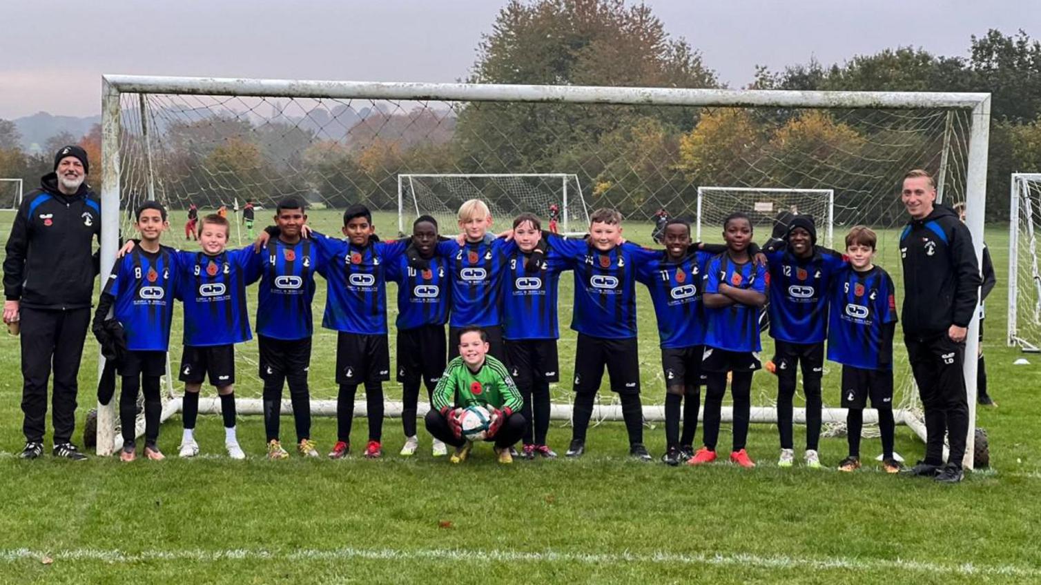 The Everett Rovers FC team lined up in front of the goal