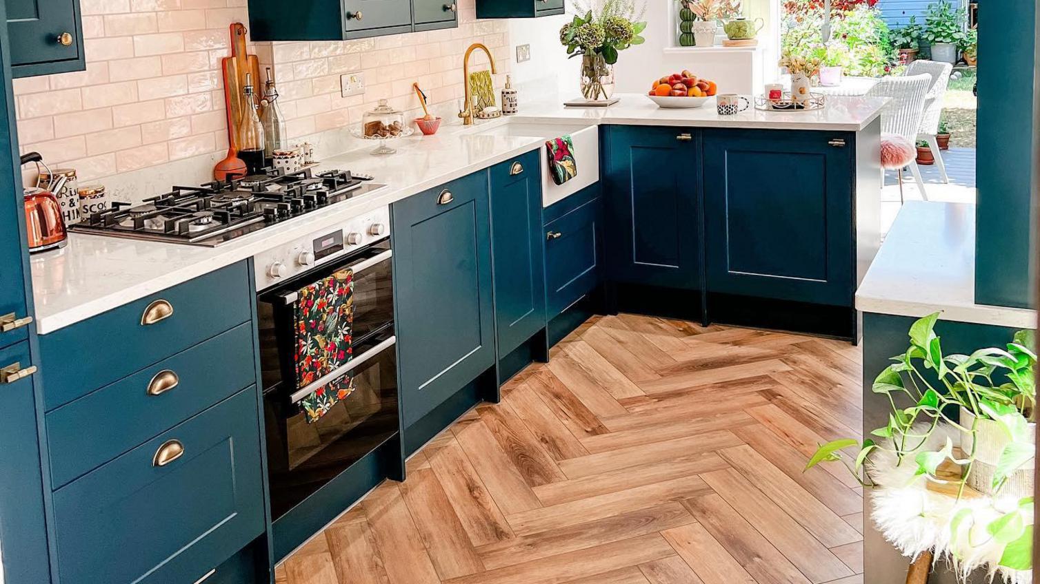 A bold, vibrant shaker kitchen with a stylish herringbone laminate flooring