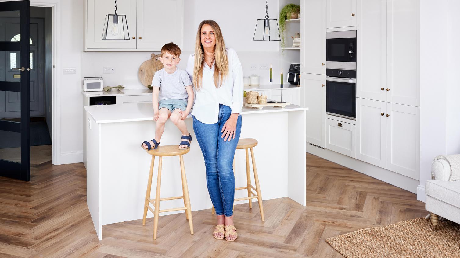 Serena and her son posing next to their kitchen island