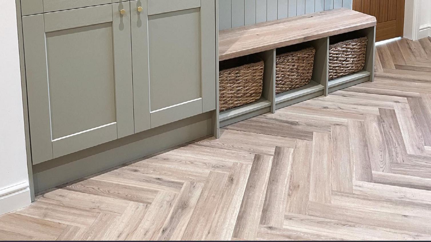 Small boot room idea featuring green, tower units, herringbone flooring, and wall panelling for a classic look.