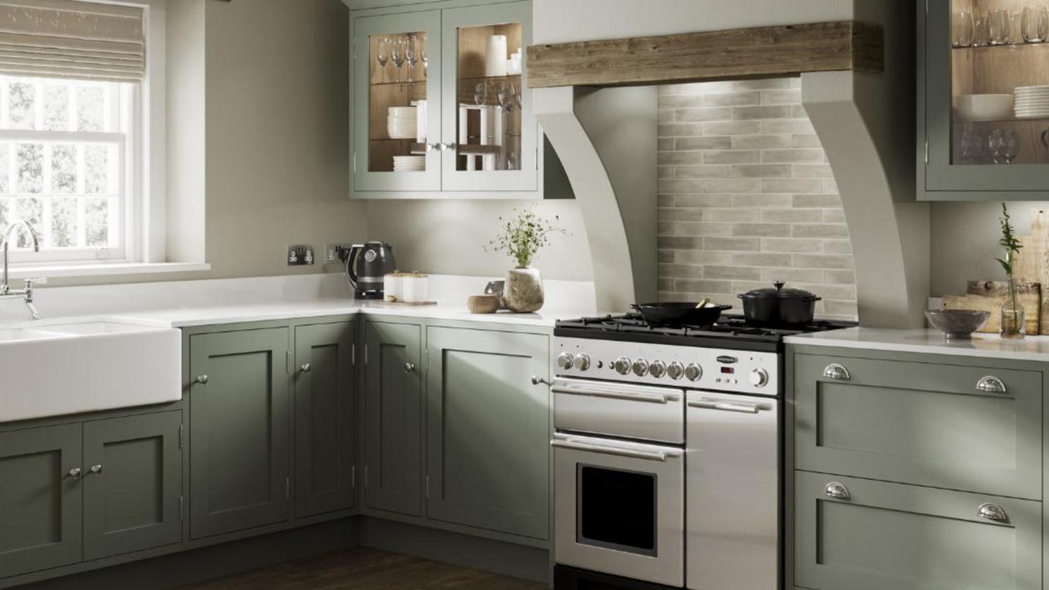 A green, shaker kitchen in a kitchen with timber beams and original features