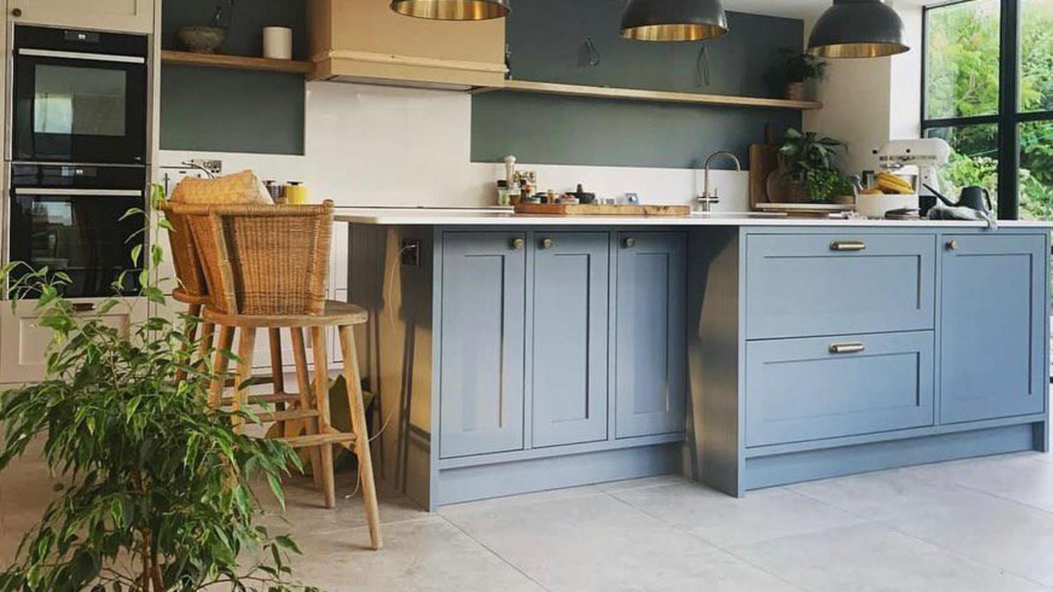 A blue in frame kitchen island with a shaker style