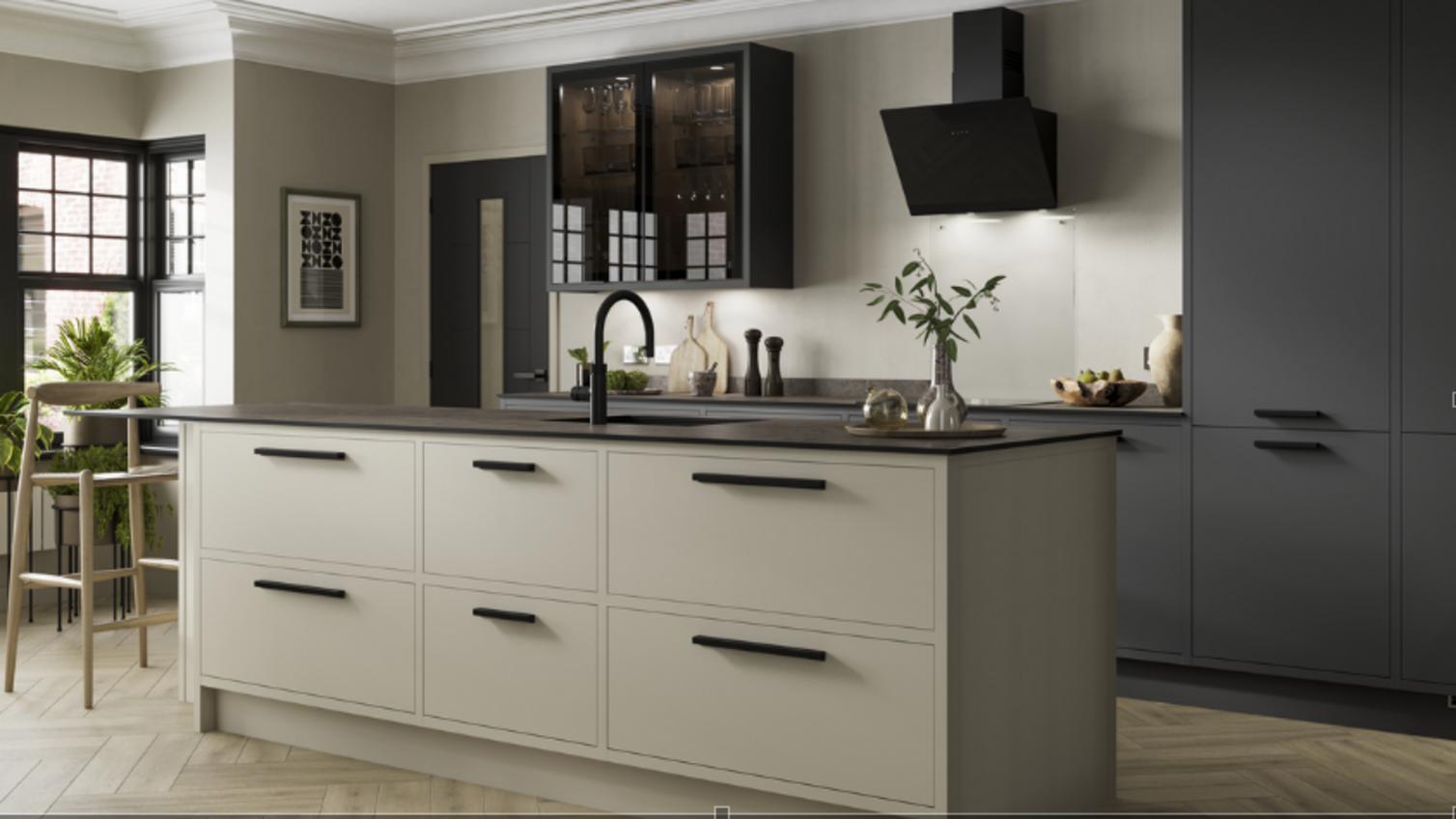An in frame, slab kitchen, in a two tone scheme, and hues of black and cream.
