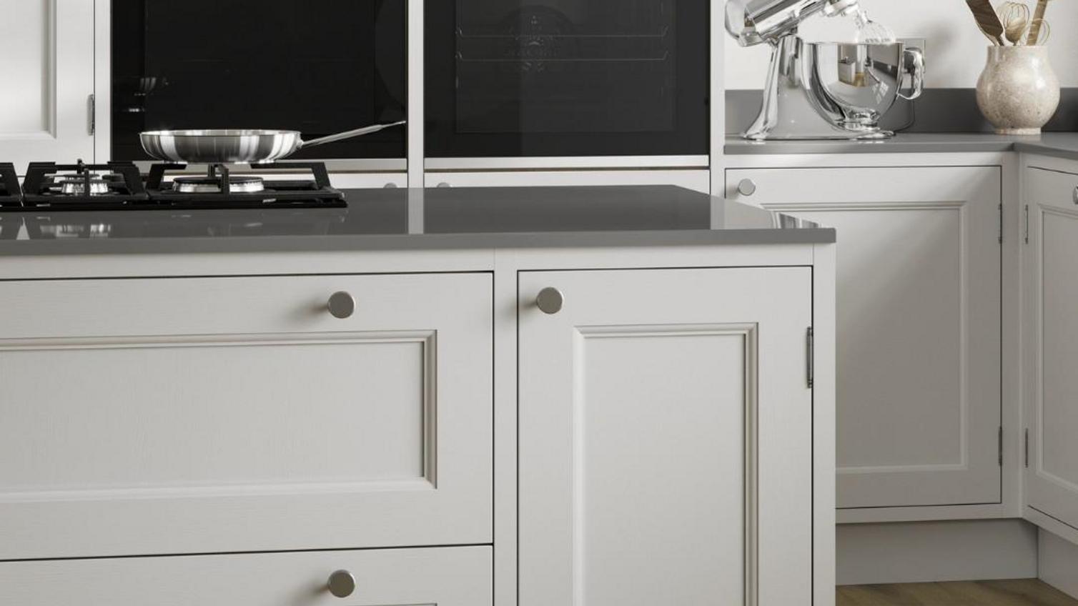 A white, in frame, shaker kitchen in an island design.