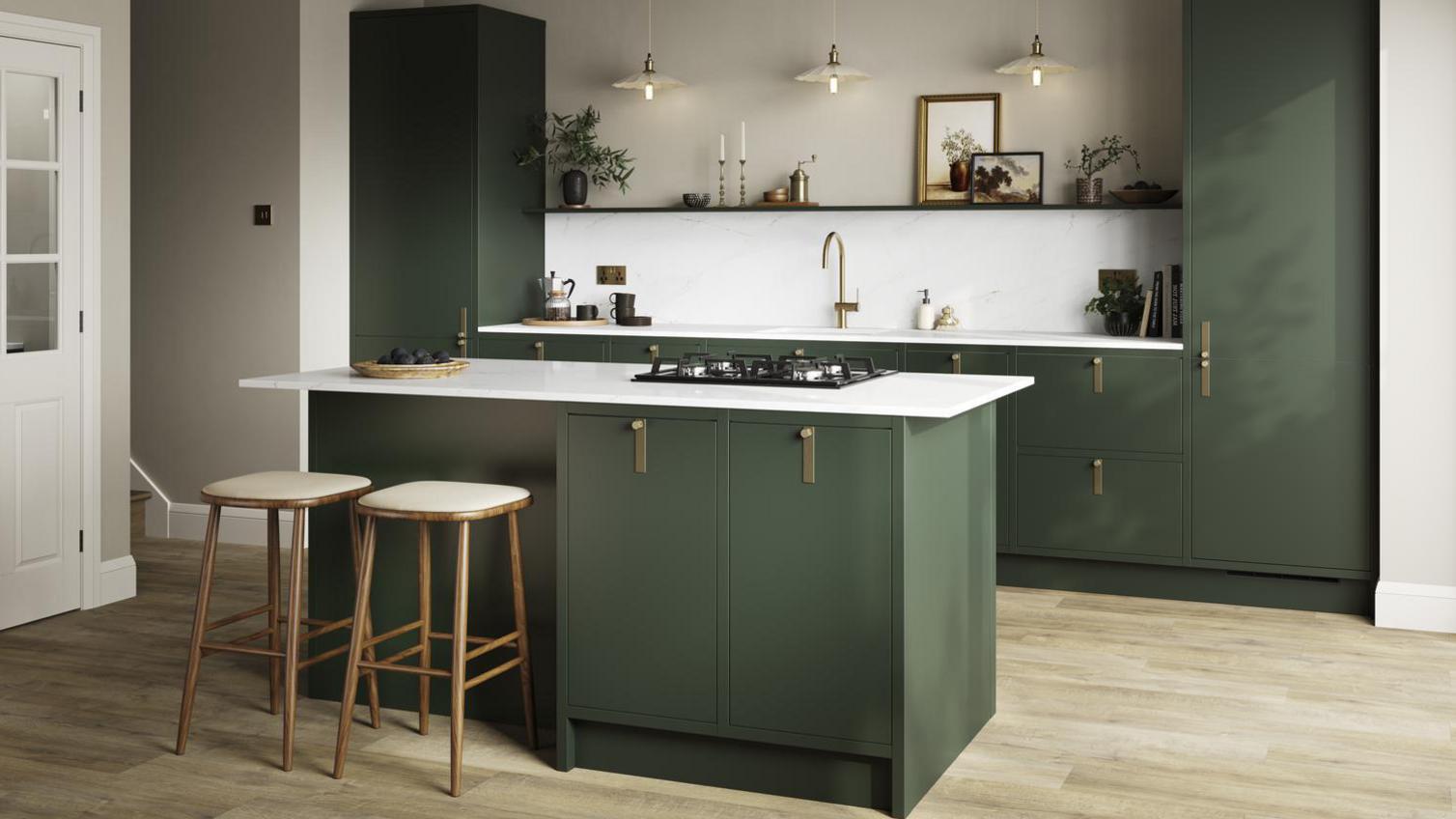 A green, slab kitchen, with an island, in frame design. It has a white counter, and wooden stools, used to create a sitting area.
