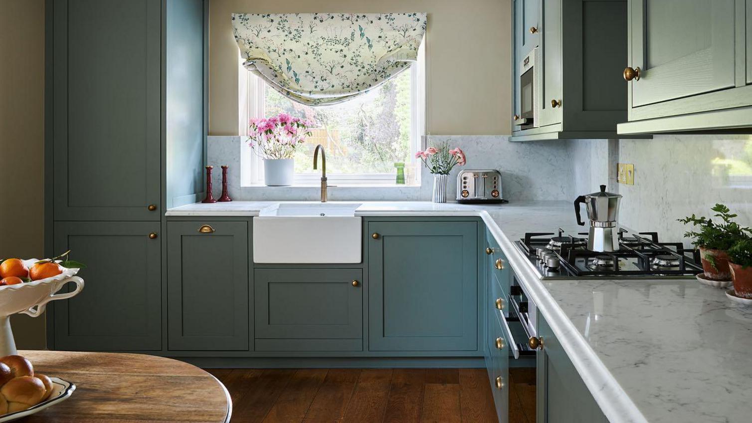 A green, in frame kitchen, with a bespoke worktop and undermount, ceramic sink